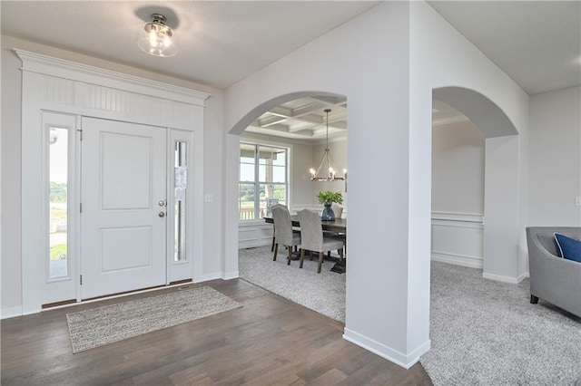 6122 Lewis Dr, Shawnee, KS 66226 - foyer with arched walkways, a chandelier, coffered ceiling, dark wood-style floors, and beamed ceiling