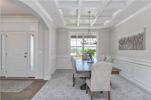 6122 Lewis Dr, Shawnee, KS 66226 - dining space with arched walkways, beam ceiling, a chandelier, crown molding, and a decorative wall