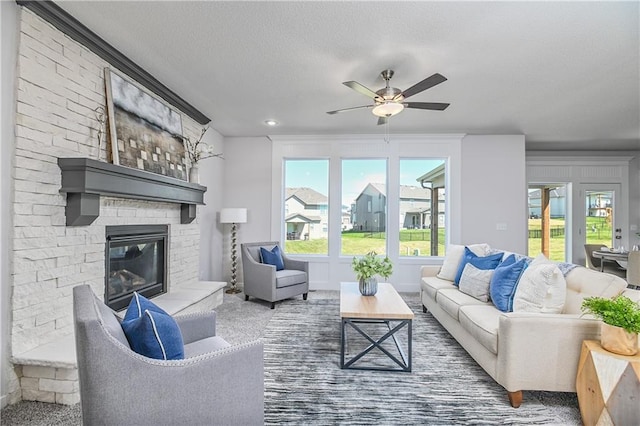 6122 Lewis Dr, Shawnee, KS 66226 - living room featuring a fireplace, ceiling fan, and carpet flooring