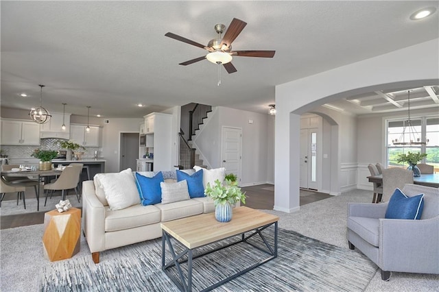 6122 Lewis Dr, Shawnee, KS 66226 - living area featuring a chandelier, arched walkways, stairway, ceiling fan, and recessed lighting