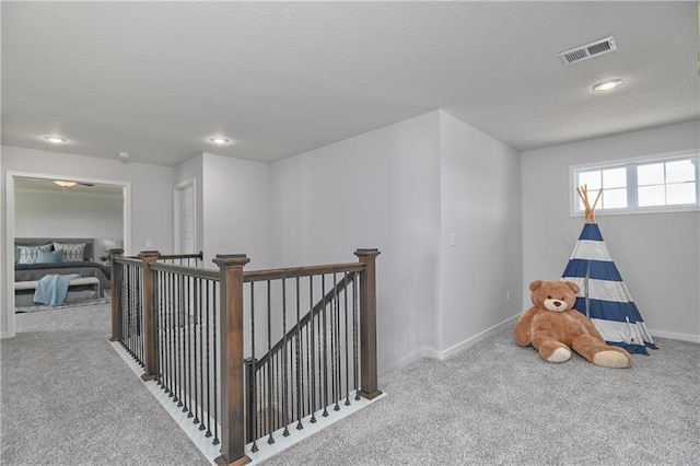 6122 Lewis Dr, Shawnee, KS 66226 - hall featuring carpet flooring, an upstairs landing, recessed lighting, and a textured ceiling