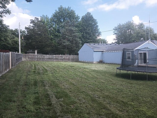1712 S Hands St, Independence, MO 64055 - fenced backyard with a trampoline