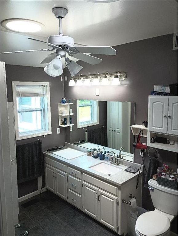 1712 S Hands St, Independence, MO 64055 - bathroom with a ceiling fan, healthy amount of natural light, double vanity, and tile patterned flooring