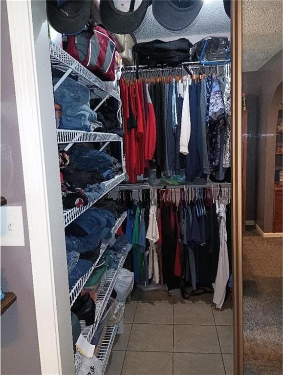 1712 S Hands St, Independence, MO 64055 - walk in closet with tile patterned flooring and arched walkways