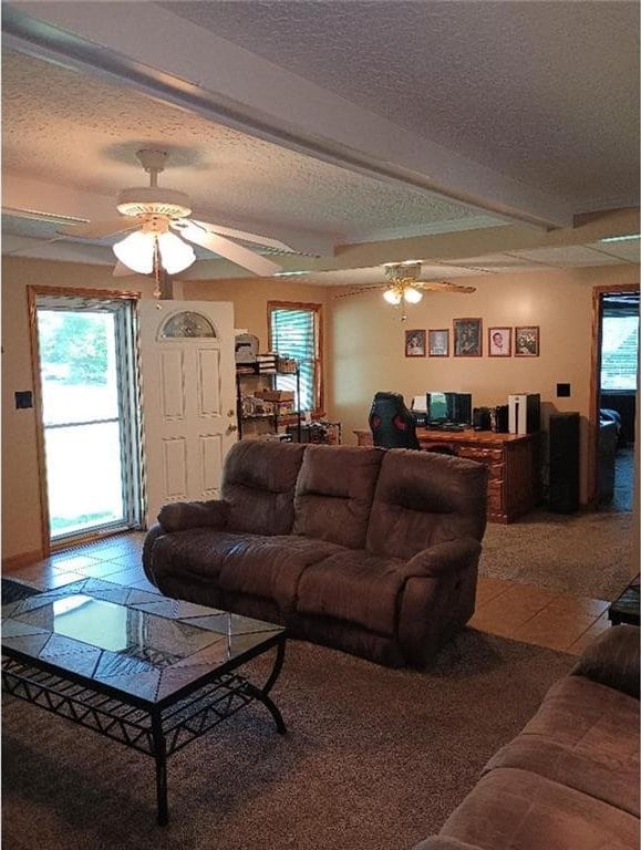 1712 S Hands St, Independence, MO 64055 - living area with a ceiling fan, a textured ceiling, and tile patterned floors