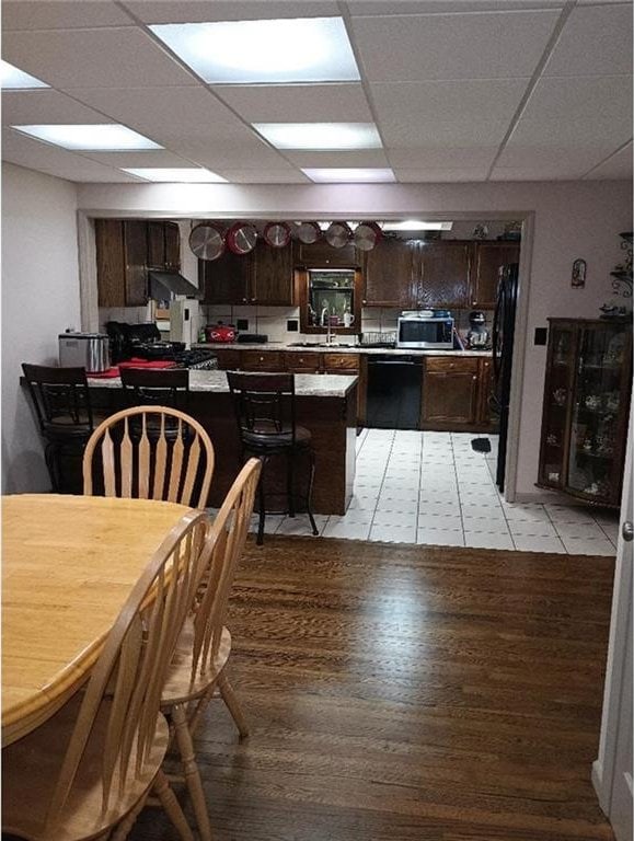 1712 S Hands St, Independence, MO 64055 - dining area with a paneled ceiling and light wood finished floors