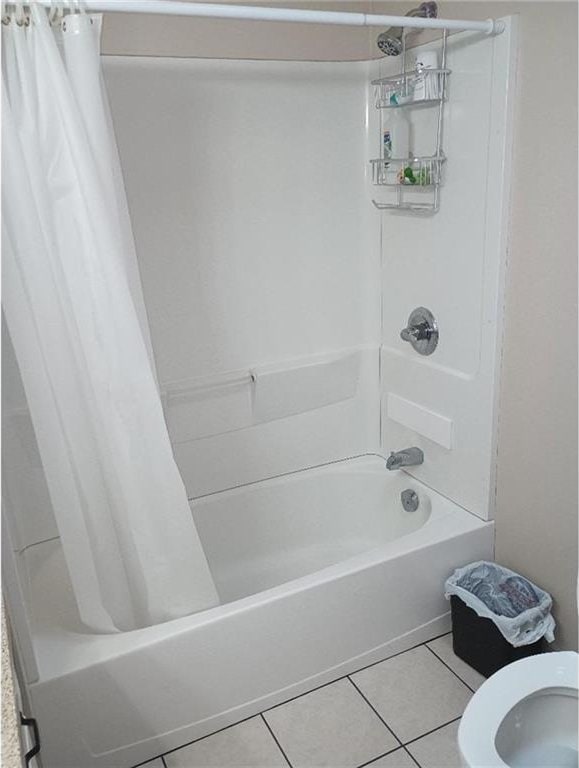 1712 S Hands St, Independence, MO 64055 - bathroom featuring shower / tub combo with curtain and tile patterned flooring