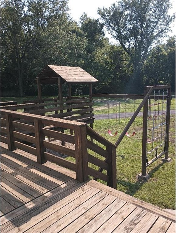 1712 S Hands St, Independence, MO 64055 - wooden terrace featuring a lawn