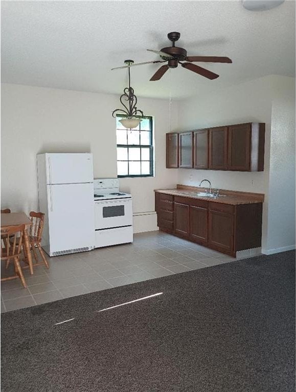 1712 S Hands St, Independence, MO 64055 - kitchen with white appliances, a ceiling fan, pendant lighting, tile patterned floors, and a textured ceiling