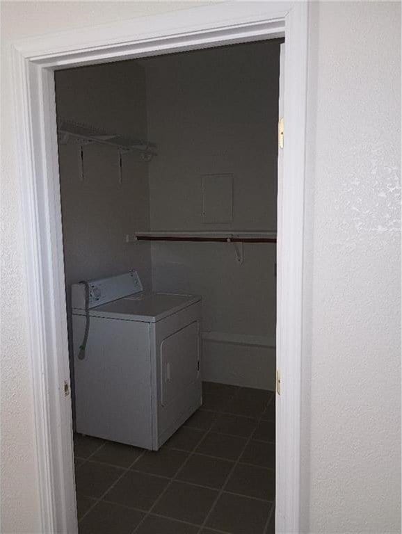 1712 S Hands St, Independence, MO 64055 - washroom with washer / dryer and dark tile patterned flooring