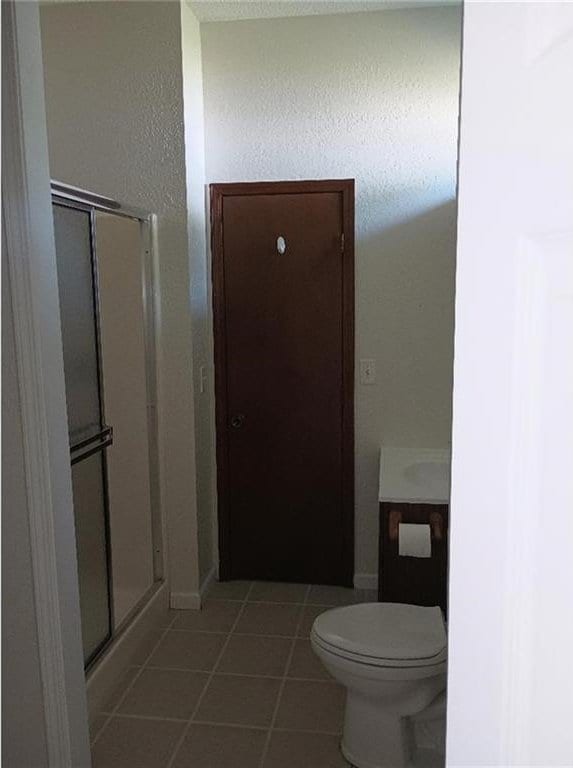 1712 S Hands St, Independence, MO 64055 - bathroom featuring tile patterned flooring, a stall shower, and vanity