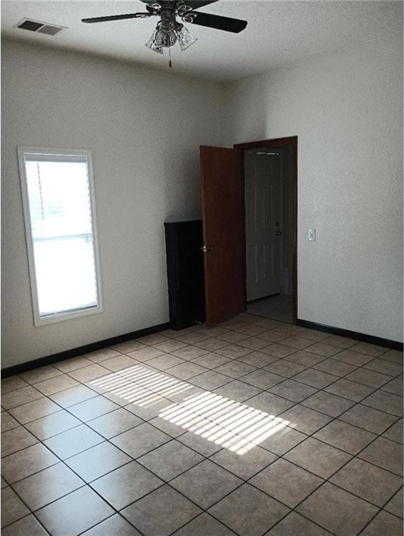 1712 S Hands St, Independence, MO 64055 - spare room with ceiling fan and light tile patterned floors