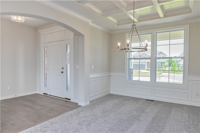 6108 Lewis Dr, Shawnee, KS 66226 - carpeted foyer with arched walkways, a chandelier, beam ceiling, coffered ceiling, and ornamental molding