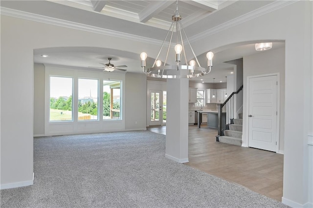 6108 Lewis Dr, Shawnee, KS 66226 - unfurnished living room featuring beam ceiling, light colored carpet, crown molding, arched walkways, and stairs