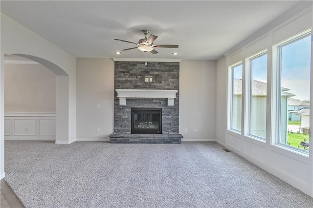 6108 Lewis Dr, Shawnee, KS 66226 - unfurnished living room featuring plenty of natural light, a ceiling fan, carpet floors, arched walkways, and ornamental molding