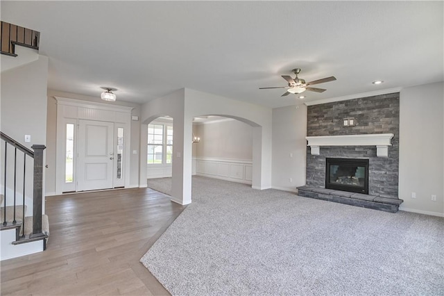 6108 Lewis Dr, Shawnee, KS 66226 - foyer with a ceiling fan, stairs, arched walkways, light wood-style flooring, and a fireplace