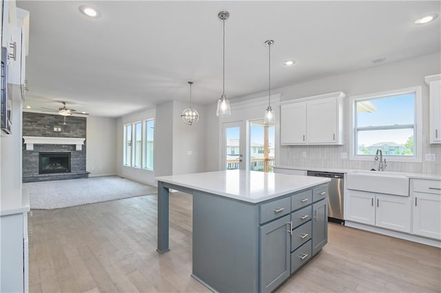 6108 Lewis Dr, Shawnee, KS 66226 - kitchen featuring dishwasher, a ceiling fan, white cabinets, open floor plan, and light countertops