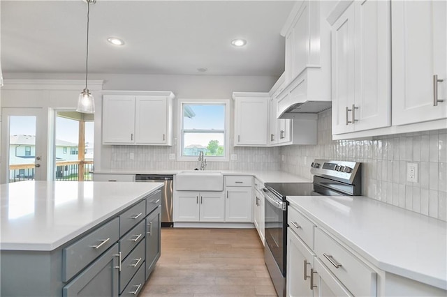 6108 Lewis Dr, Shawnee, KS 66226 - kitchen with appliances with stainless steel finishes, gray cabinets, light countertops, white cabinets, and light wood-style floors