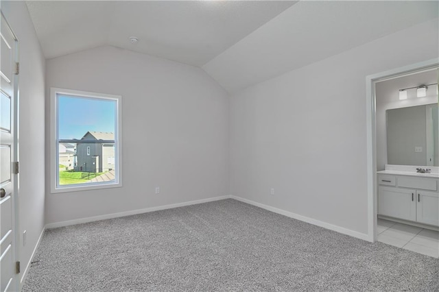 6108 Lewis Dr, Shawnee, KS 66226 - unfurnished bedroom featuring light colored carpet, lofted ceiling, and connected bathroom