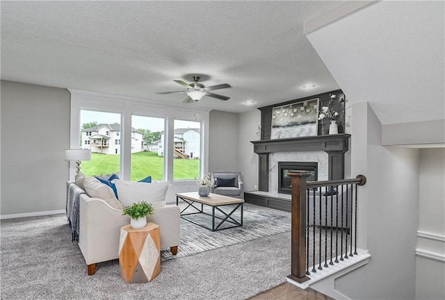 6118 Lewis Dr, Shawnee, KS 66226 - living room featuring ceiling fan, a textured ceiling, and a premium fireplace