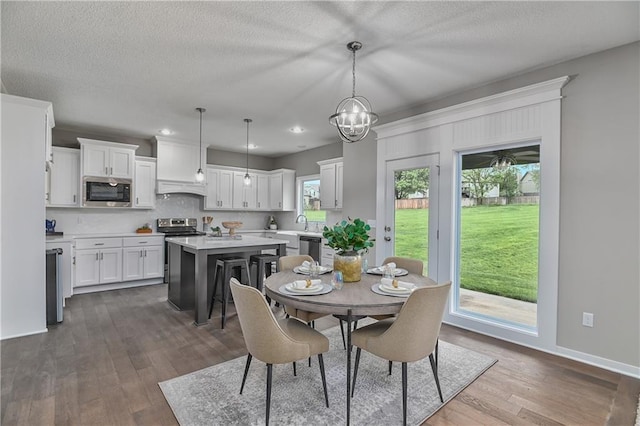 6118 Lewis Dr, Shawnee, KS 66226 - dining room featuring dark wood finished floors, a textured ceiling, recessed lighting, and a chandelier
