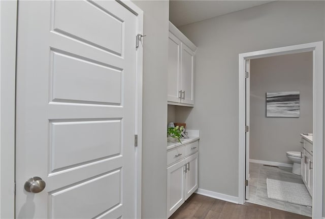 6118 Lewis Dr, Shawnee, KS 66226 - laundry room with baseboards and dark wood finished floors