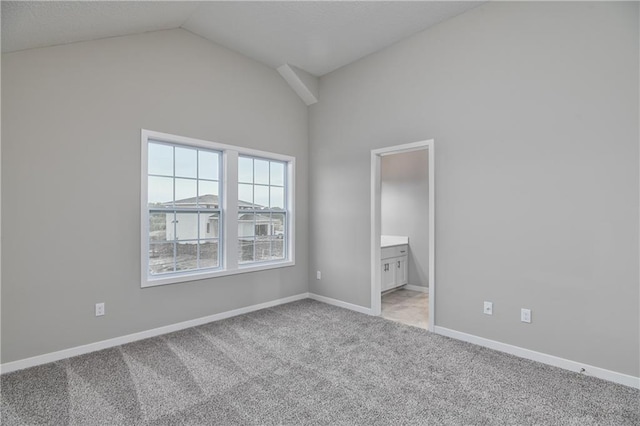 6118 Lewis Dr, Shawnee, KS 66226 - unfurnished bedroom with vaulted ceiling, light carpet, and ensuite bath