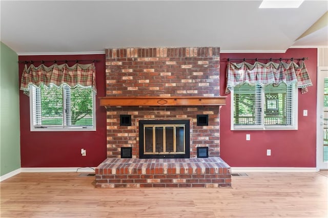 32204 Apple Hill Dr, Paola, KS 66071 - living area with ornamental molding, wood finished floors, and a brick fireplace
