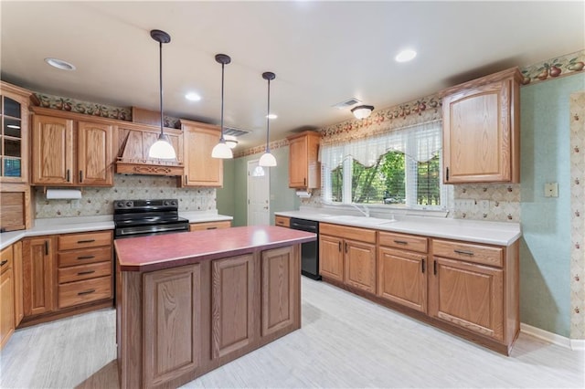 32204 Apple Hill Dr, Paola, KS 66071 - kitchen featuring black appliances, tasteful backsplash, a kitchen island, custom range hood, and decorative light fixtures