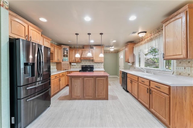 32204 Apple Hill Dr, Paola, KS 66071 - kitchen with black appliances, a center island, light countertops, decorative backsplash, and recessed lighting