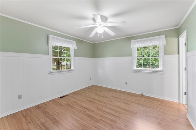 32204 Apple Hill Dr, Paola, KS 66071 - empty room featuring wood finished floors, wainscoting, ceiling fan, and ornamental molding