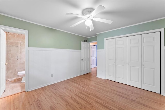 32204 Apple Hill Dr, Paola, KS 66071 - unfurnished bedroom with light wood-type flooring, ornamental molding, wainscoting, a closet, and a ceiling fan