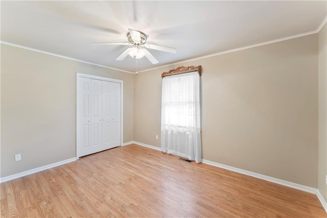 32204 Apple Hill Dr, Paola, KS 66071 - unfurnished bedroom with light wood finished floors, ornamental molding, a closet, and a ceiling fan
