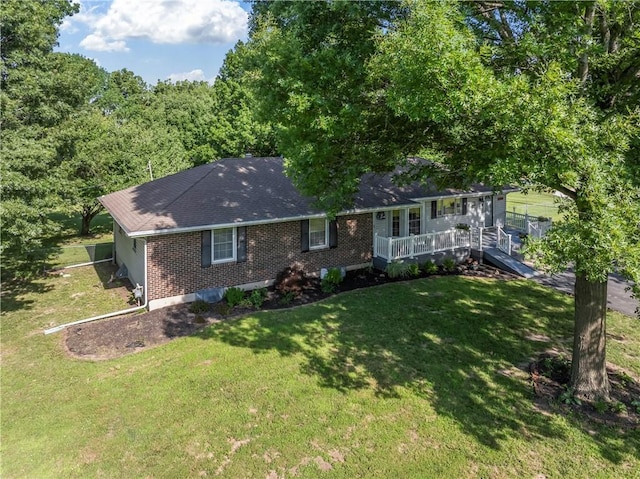 32204 Apple Hill Dr, Paola, KS 66071 - single story home featuring brick siding, a front lawn, a wooden deck, and a shingled roof
