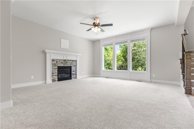 16779 S Durango St, Olathe, KS 66062 - unfurnished living room with carpet, ceiling fan, stairs, and a fireplace