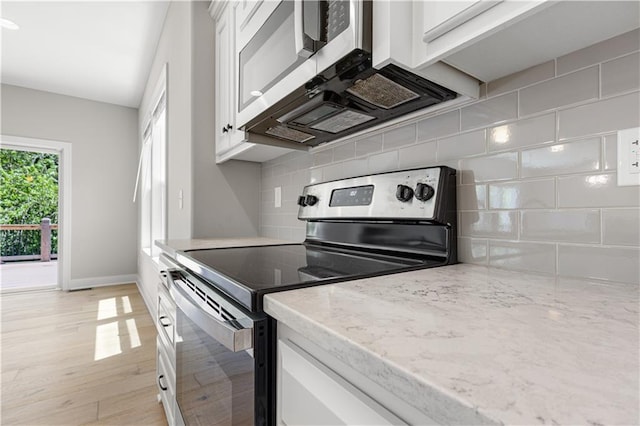 16779 S Durango St, Olathe, KS 66062 - kitchen with stainless steel electric range, white cabinets, backsplash, and light stone counters