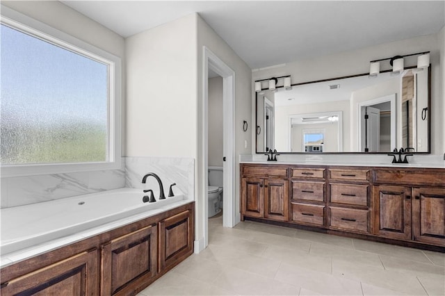 16779 S Durango St, Olathe, KS 66062 - bathroom with double vanity, a garden tub, plenty of natural light, and tile patterned flooring