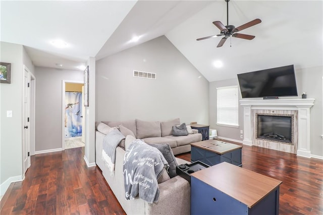 968 E Market St, Warrensburg, MO 64903 - living area featuring a ceiling fan, a tiled fireplace, wood finished floors, and high vaulted ceiling
