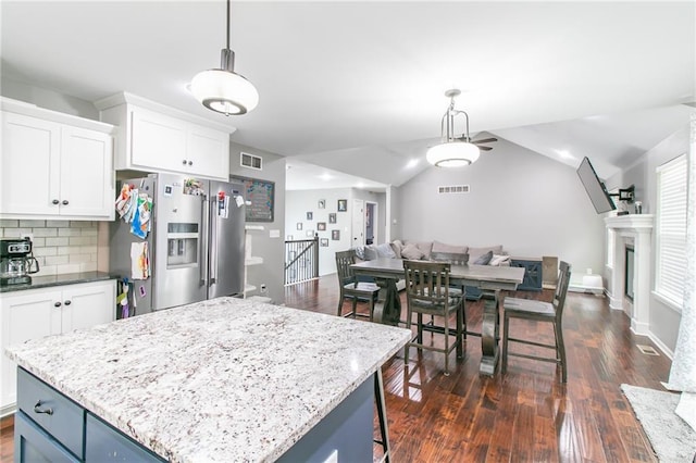968 E Market St, Warrensburg, MO 64903 - kitchen featuring stainless steel refrigerator with ice dispenser, open floor plan, dark wood-style floors, white cabinets, and decorative backsplash
