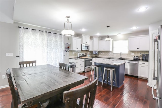 968 E Market St, Warrensburg, MO 64903 - dining room with dark wood-style floors and recessed lighting