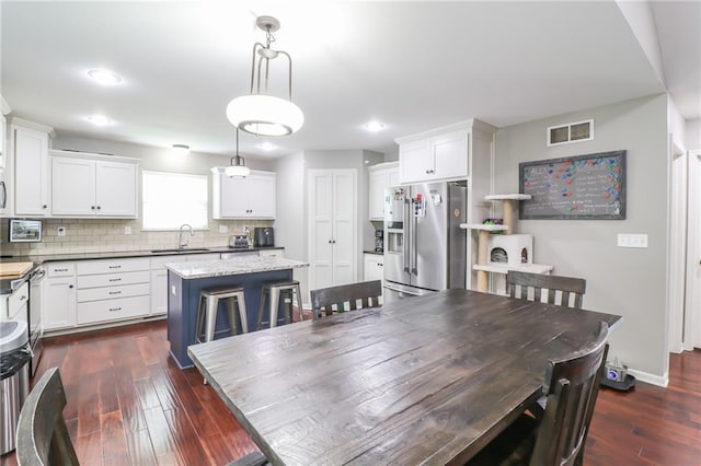 968 E Market St, Warrensburg, MO 64903 - dining area featuring dark wood-style floors and recessed lighting