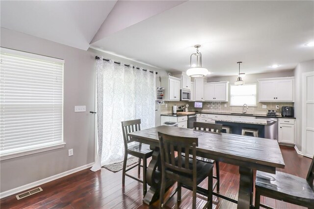 968 E Market St, Warrensburg, MO 64903 - dining area with dark wood-style flooring, recessed lighting, and lofted ceiling