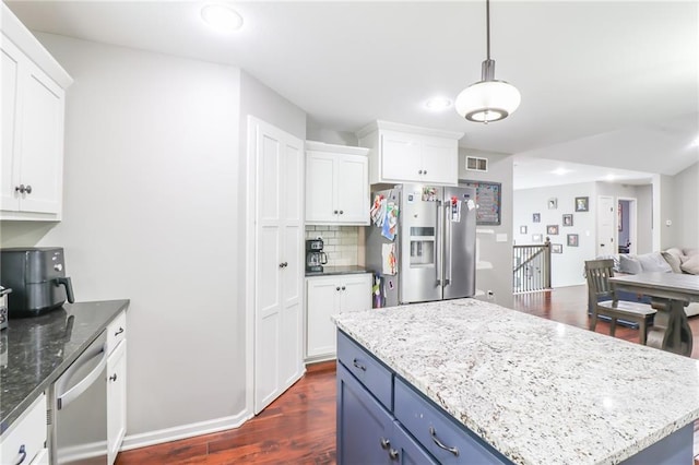 968 E Market St, Warrensburg, MO 64903 - kitchen with appliances with stainless steel finishes, white cabinetry, open floor plan, dark wood-type flooring, and recessed lighting
