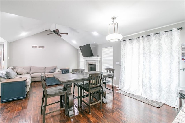 968 E Market St, Warrensburg, MO 64903 - dining space with a ceiling fan, vaulted ceiling, dark wood-style floors, and a fireplace