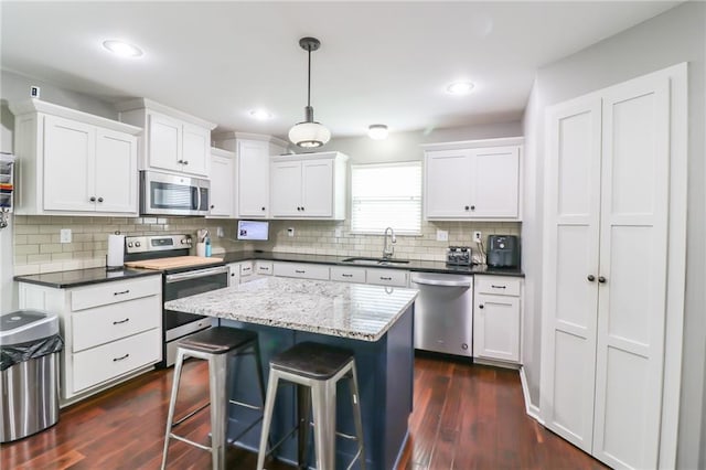 968 E Market St, Warrensburg, MO 64903 - kitchen featuring stainless steel appliances, white cabinets, a center island, and recessed lighting