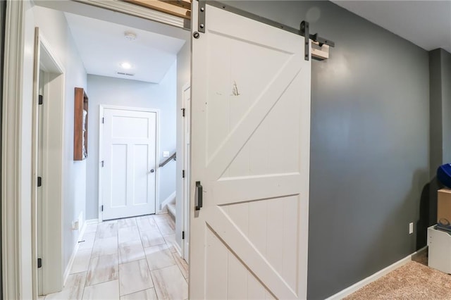 968 E Market St, Warrensburg, MO 64903 - hall featuring a barn door and stairway
