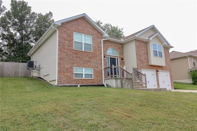 968 E Market St, Warrensburg, MO 64903 - view of front facade with a garage, brick siding, and driveway