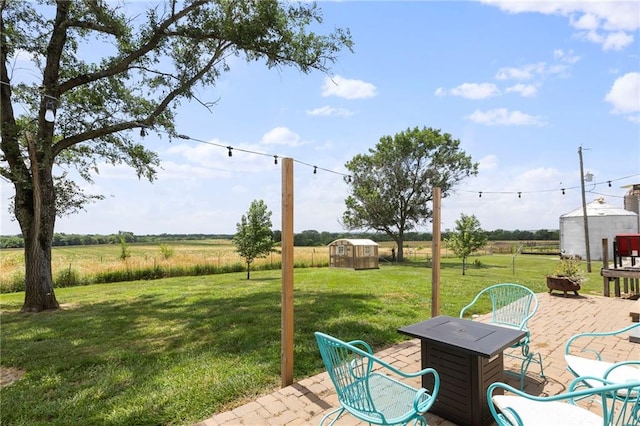 24245 K 68 Hwy, Paola, KS 66071 - view of green lawn featuring a patio, a view of rural / pastoral area, and a storage shed