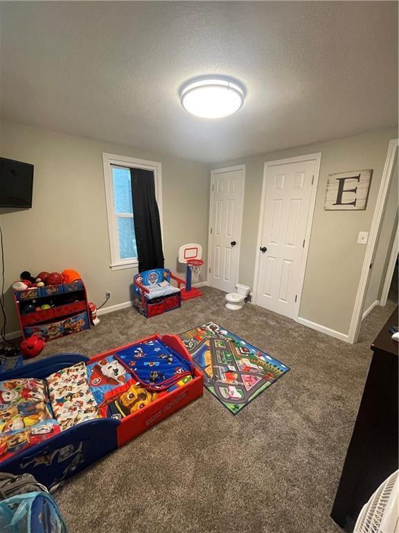 400 N Institute St, Richmond, MO 64085 - game room featuring carpet floors and a textured ceiling