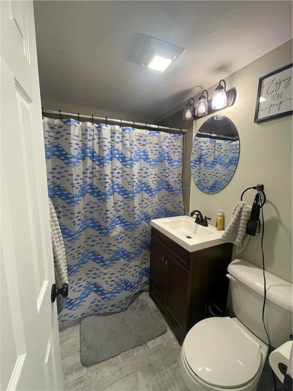 400 N Institute St, Richmond, MO 64085 - full bathroom featuring vanity and a shower with curtain